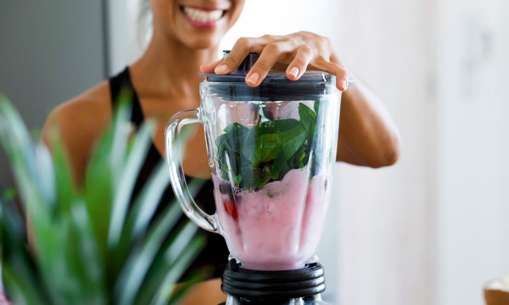 woman blending fruit in a blender