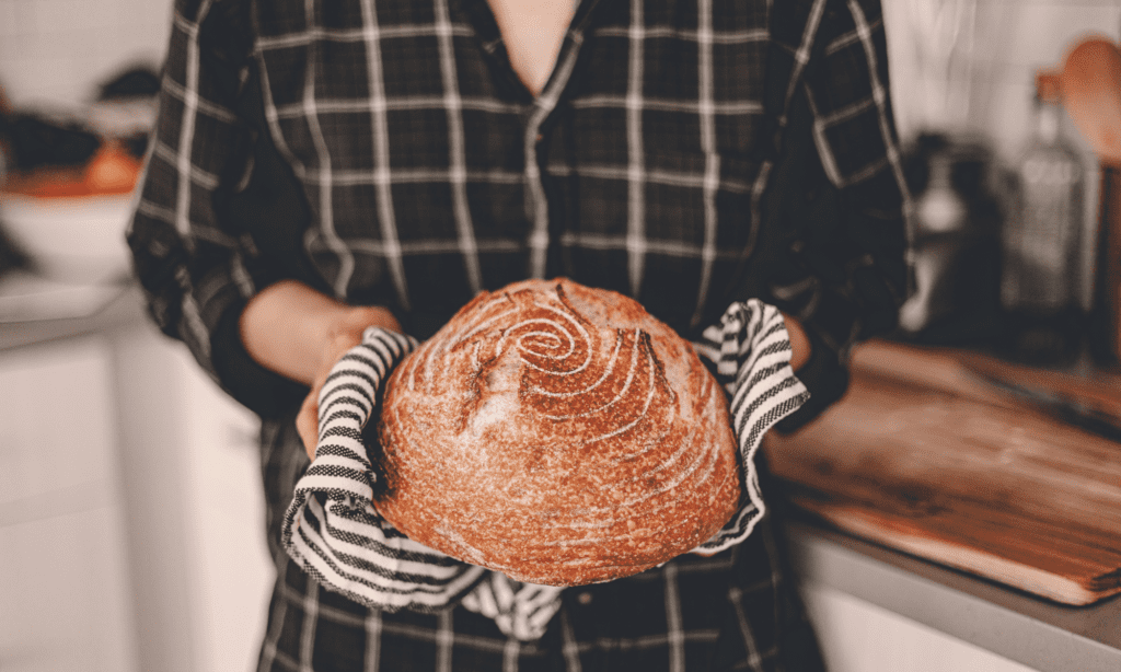 woman holding fresh baked homemade bread