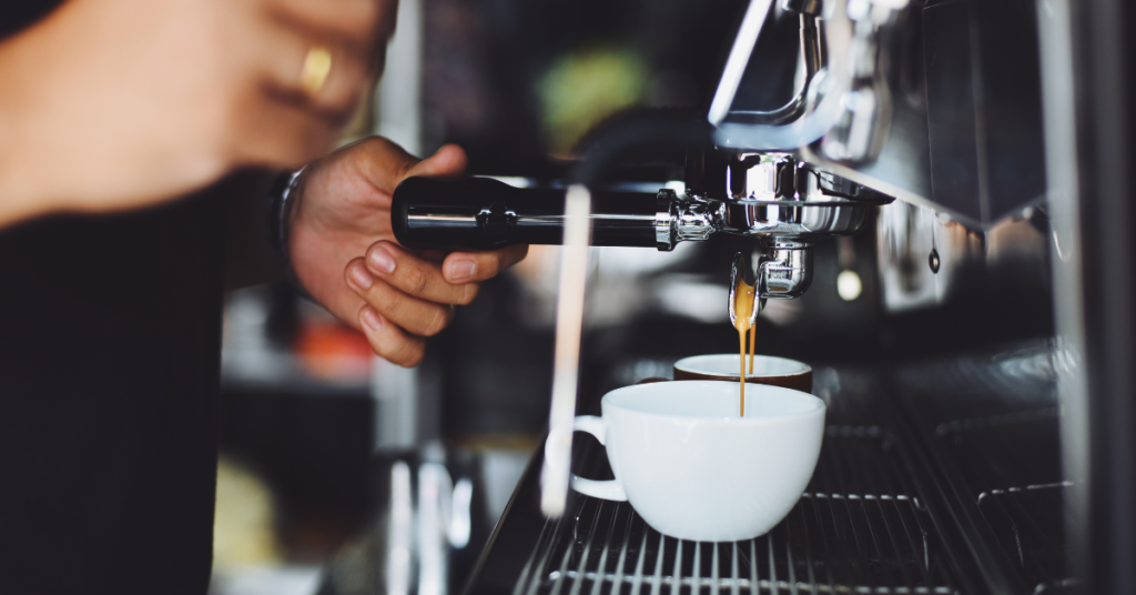 Close up shot of espresso machine and coffee pouring into cup