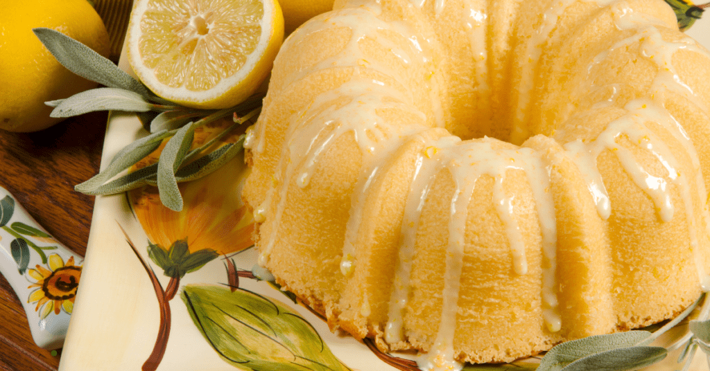 lemon bundt cake on a plater with lemon slices around it